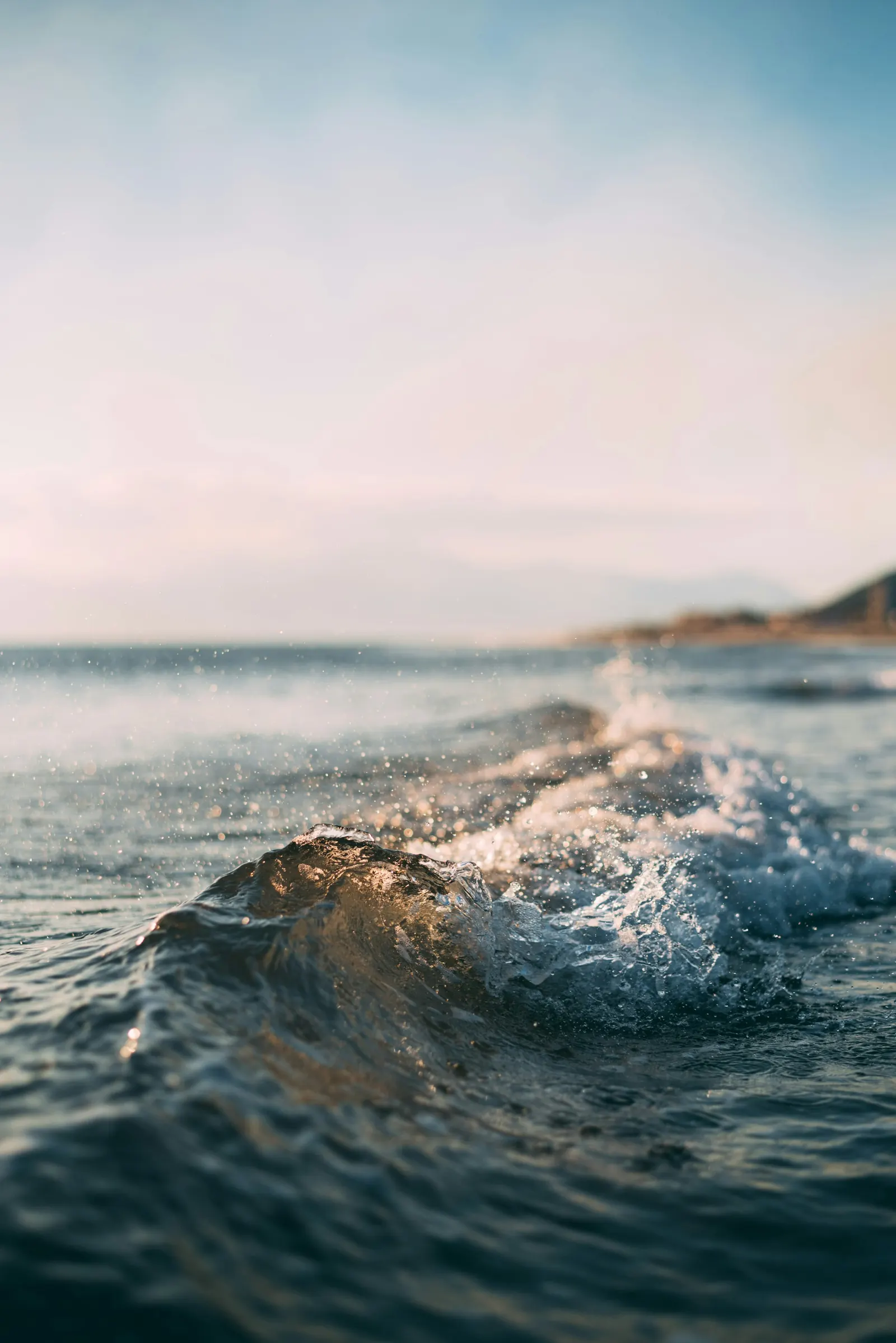 A wave breaking in the shallow nearshore zone, where wave energy is dissipated and beach sediment is mobilised