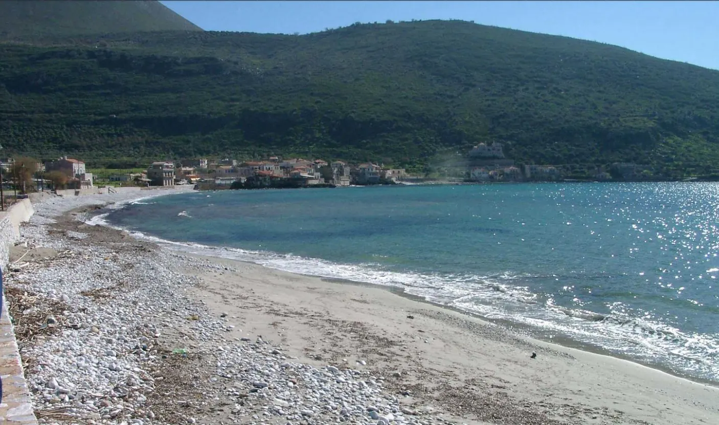 The bay at Oitylo, Laconia, after shoreline restoration, with the village and forested slopes behind the beach
