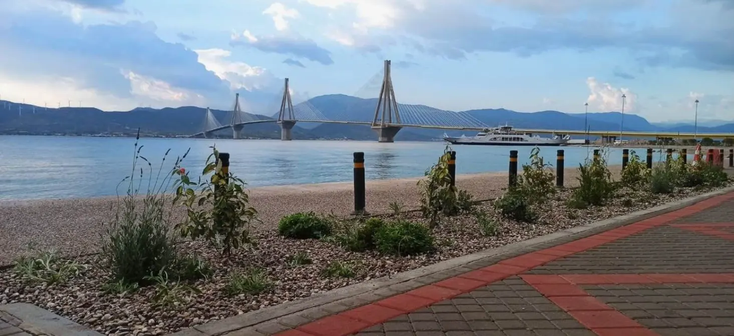 The completed Rio-Aktaio seafront, with new planting, a paved walkway and the Rio-Antirrio bridge beyond