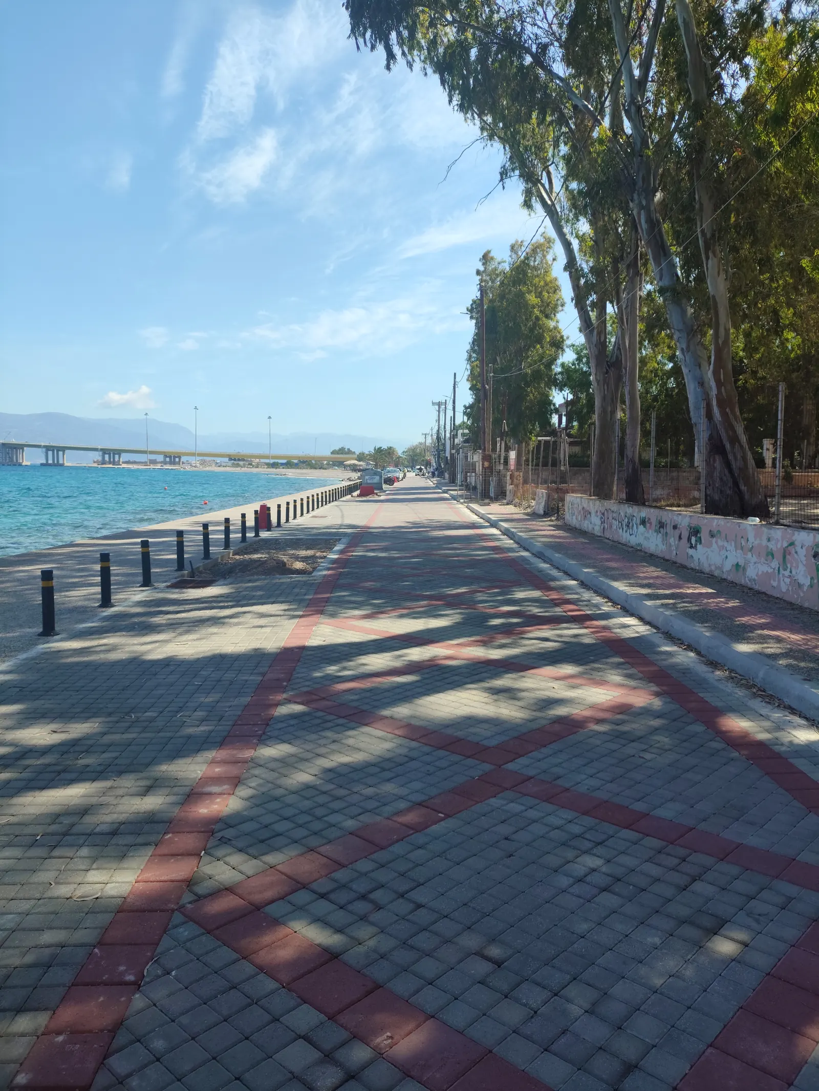 The paved seafront promenade at Rio-Aktaio, Achaea, with the Rio-Antirrio bridge in the distance