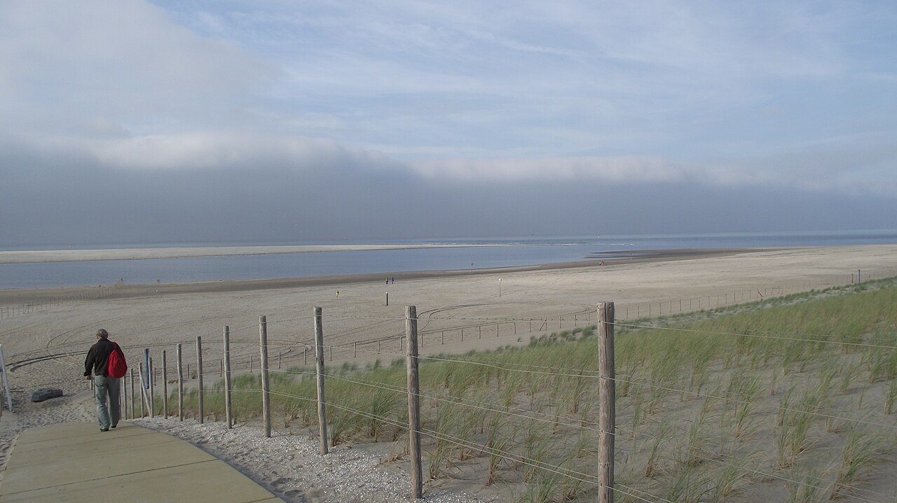 The Sand Motor (Zandmotor) hook-shaped mega-nourishment peninsula on the Delfland coast of South Holland, Netherlands, viewed from the beach shortly after completion in 2011